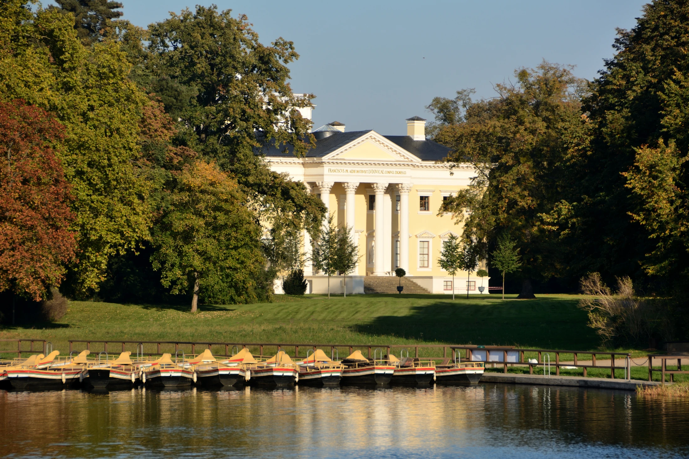 Wörlitz Palace among autumn trees, with gondolas and water in front